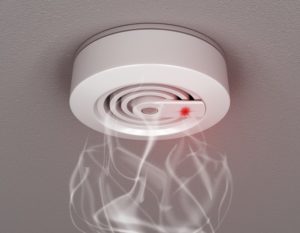 A fire alarm and smoke detector on a wall