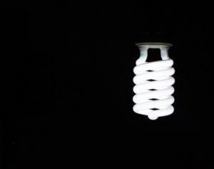 A single light bulb in a dark room A single light bulb in a dark room